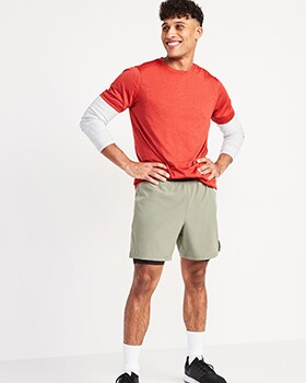 A model wears a red Core tee and activewear shorts