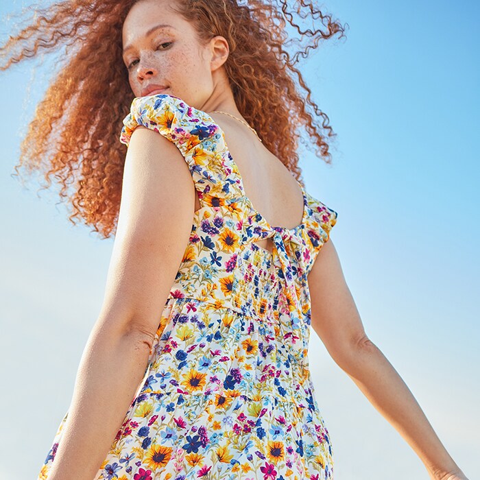 A female model wears a floral dress.