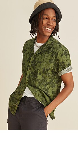 A male model wears a short sleeve Relaxed-Fit Floral Linen-Blend Camp Shirt.