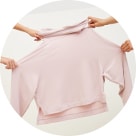 Image of hands extended holding .a pink lounge top