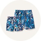Image of family-matching tropical printed swim trunks