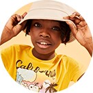A young model wearing a graphic t-shirt and a light color bucket hat.
