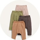 A set of four pants in neutral tones.