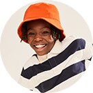 A young model wearing stripped flex polo shirt and an orange bucket hat.