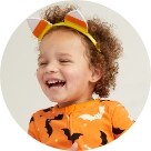 A toddler girl model wearing a Halloween themed outfit.
