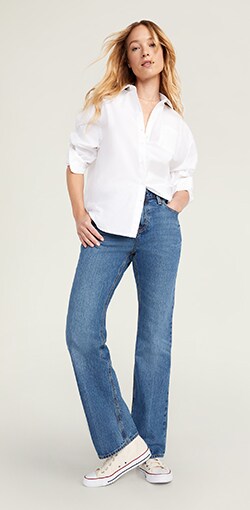 Relaxed fit medium wash dad jeans paired with an oversized white button down shirt.