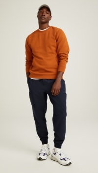 A male model wears Stretch Tech style activewear.