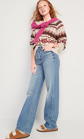 A female model wears a fair isle sweated and wide leg jeans.