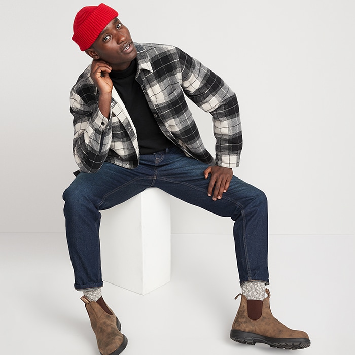 A male model wears Old Navy new arrivals including a plaid flannel with dark wash jeans.