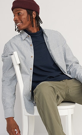 A male model wears a blue pinstripe Regular-Fit Non-Stretch Everyday Oxford Shirt
