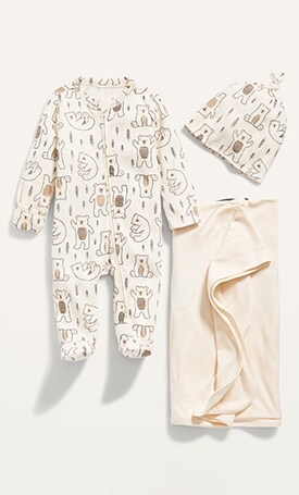 Image displays newborn essentials featuring printed footed one-piece with matching hat and blanket.