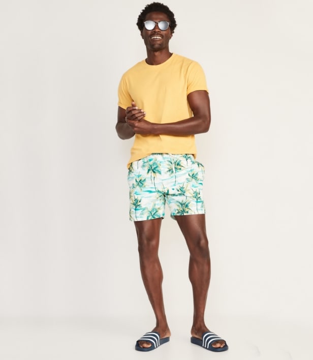 A male model wearing print swim 5" trunk and a basic t-shirt