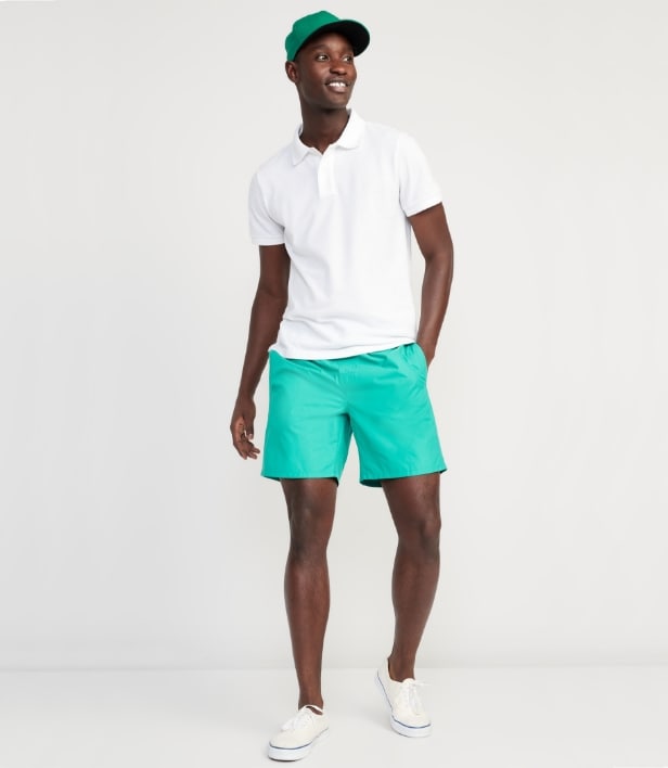 Model dressed in solid swim 7" trunk and a polo t-shirt.