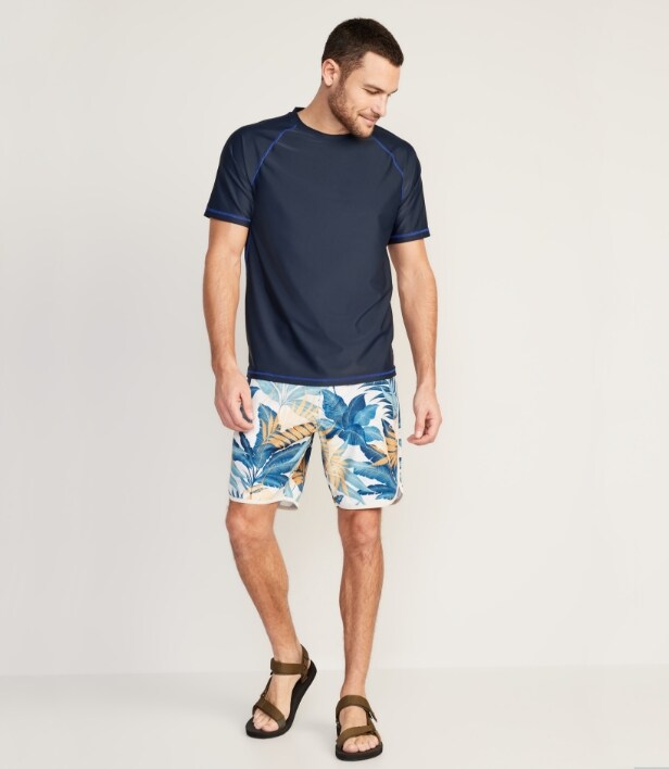 A male model wearing printed swim rashguard and solid go-dry performance t-shirt.