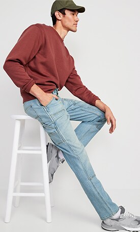 A male model wears light washed jeans
