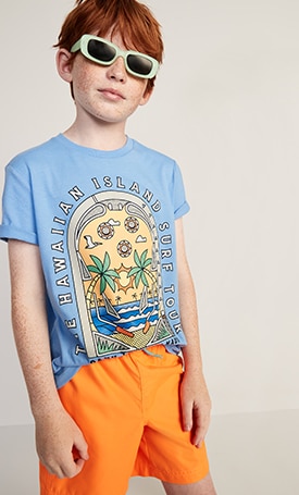 A young model wearing softest crew neck graphic tee and solid swim trunks for boys.