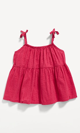 Image features pink tie-shoulder swing top for toddler.