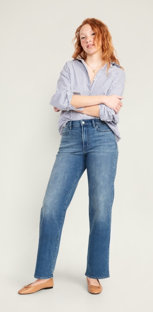 A female model wearing high waisted wow loose jeans and button down shirt.