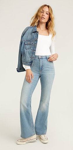 A woman in a pair of super light wash flare leg jeans.