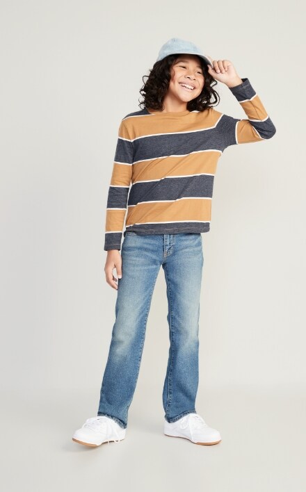 A male model wearing boot-cut built-in flex jean and striped crew neck softest long sleeve tee.