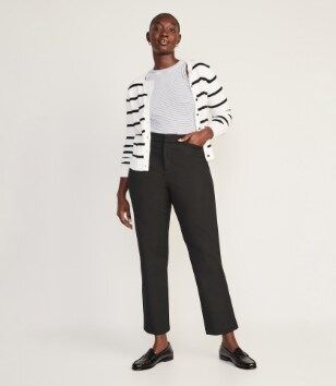 A female model wearing light colored Pixie Straight style pants
