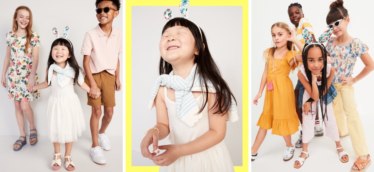 A young girl in a white tulle dress, paired with a white cardigan, and a bunny ear headband accessory.  A group of girls and boys in  dressy spring attire ranging from bright orange dresses, dark denim jeans, yellow capri pants, white buttondown shirts, and floral tops.