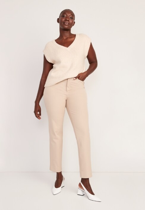 A female model wearing light colored Pixie Straight style pants