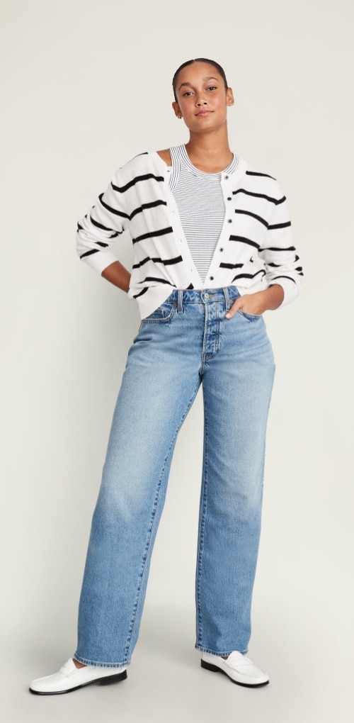 A model dressed in high waisted curvy OG loose jean and a button down sweater.