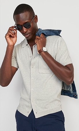 A male model wears a light colored short sleeve button up shirt