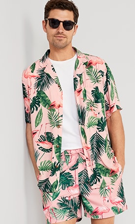 A male model wears a Birds of Paradise printed top & bottom swim set