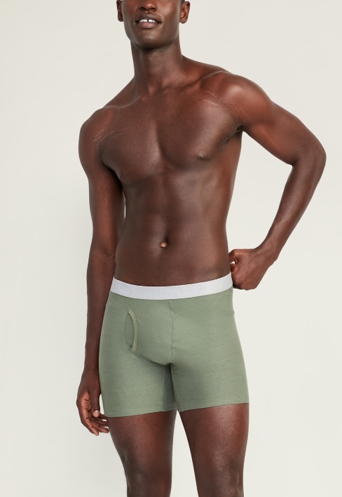 A male model wearing a pair of green boxer brief style underwear