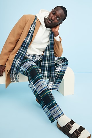 A male model wearing printed flannel jogger pajama pant.