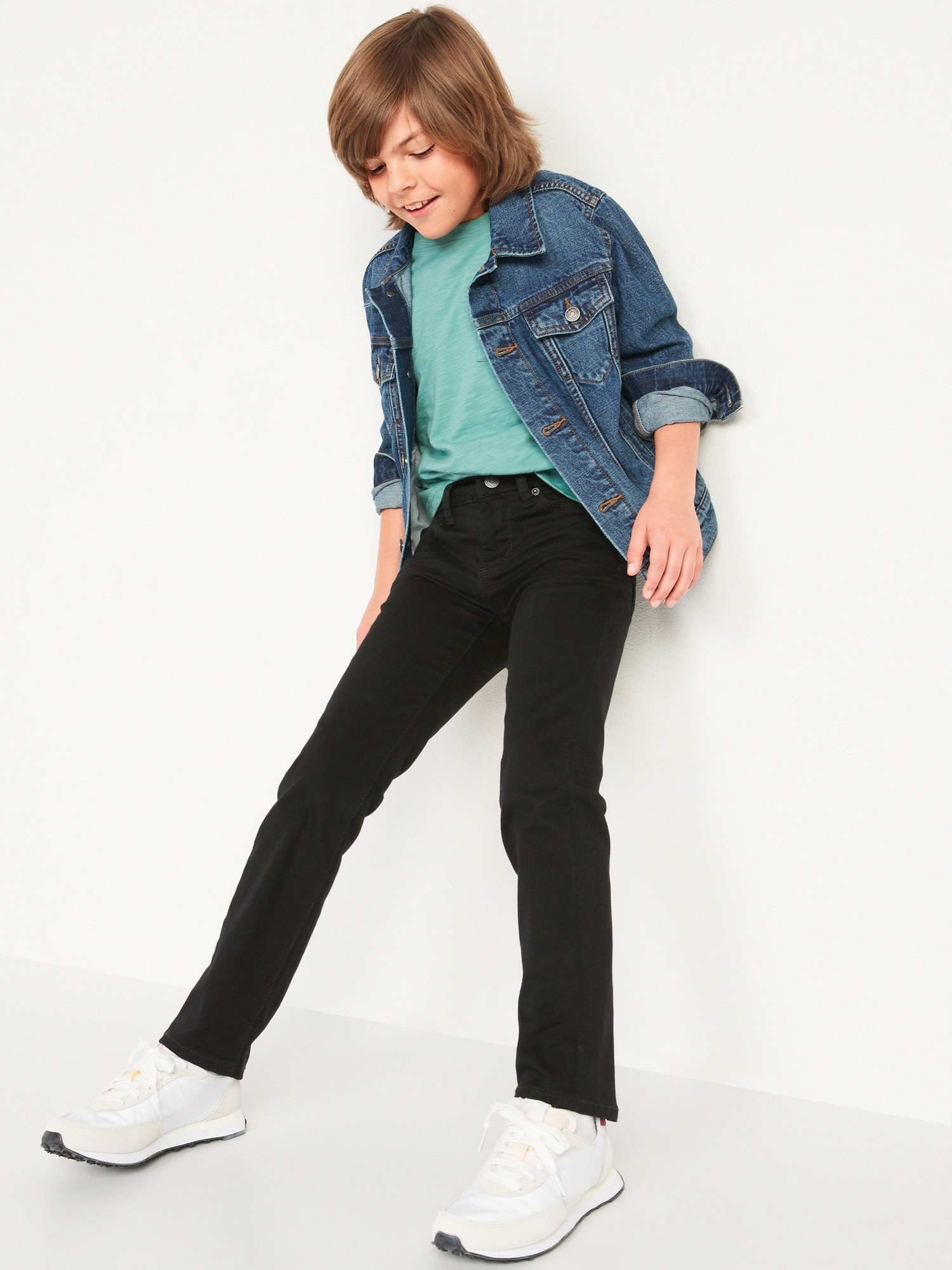 a little boy 7 years old, in a white shirt and black pants with Stock Photo  | Adobe Stock