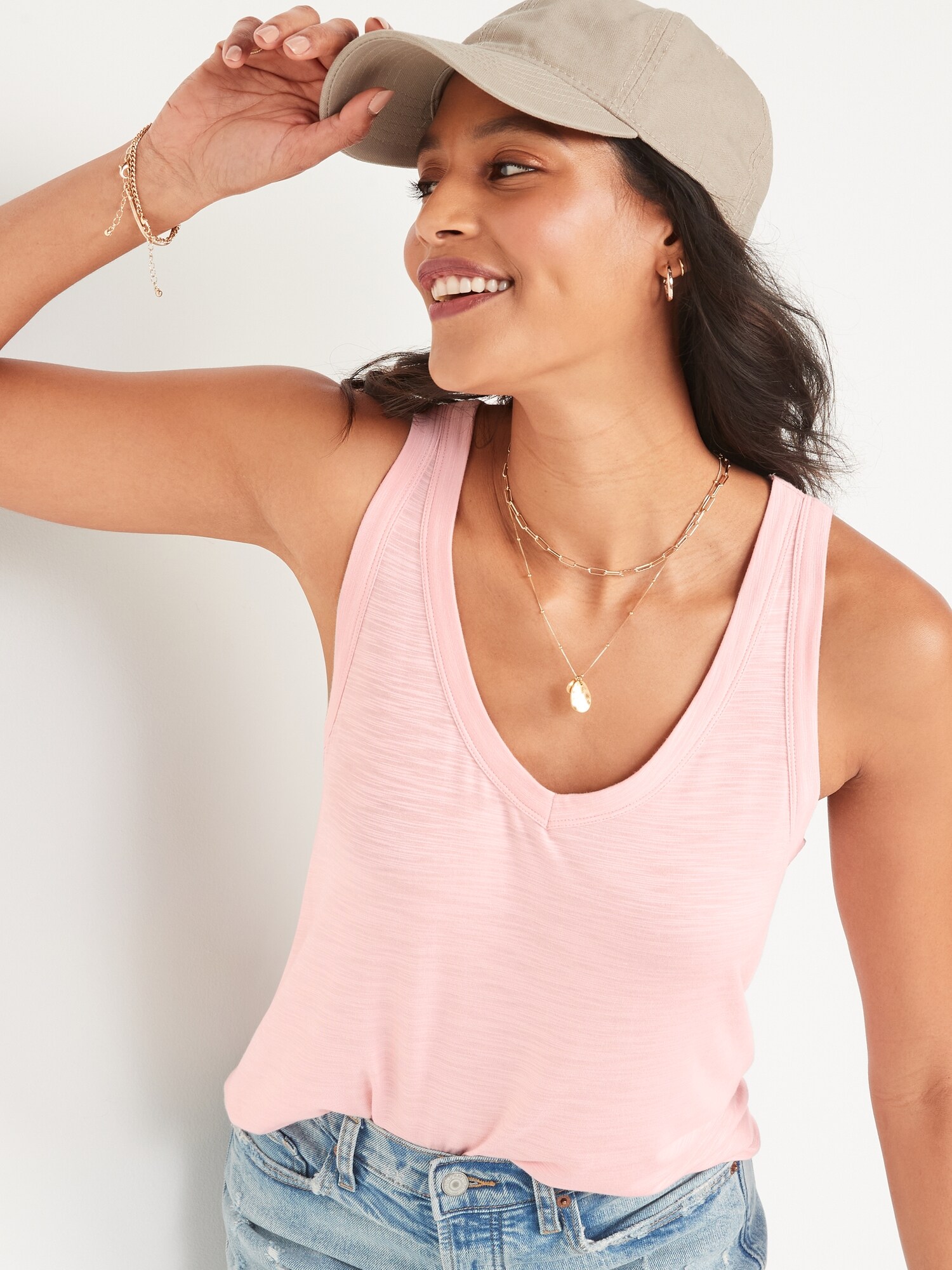 a woman wearing a light pink tank top