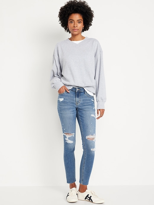 Image number 1 showing, Mid-Rise Rockstar Super-Skinny Ripped Cut-Off Ankle Jeans